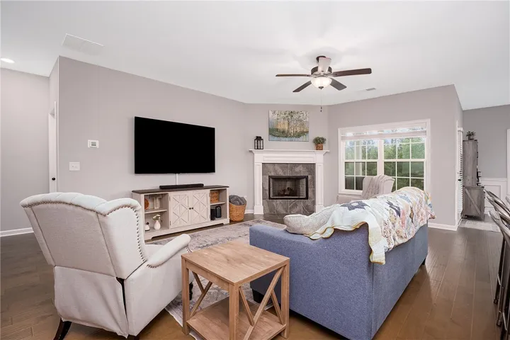 A corner fireplace adds comfort to this naturally illuminated living space.