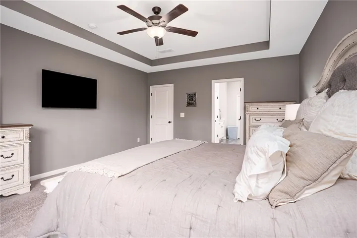 Recessed ceiling details enhance this cozy bedroom, offering a peaceful retreat.