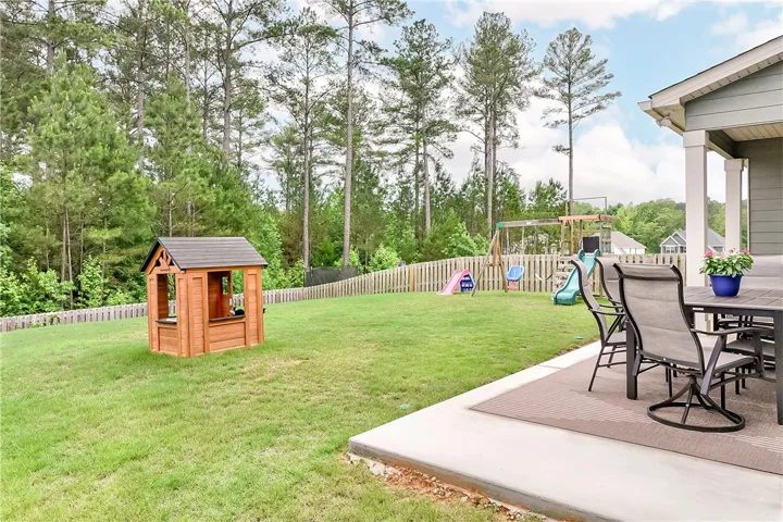 A spacious, fenced backyard with a patio perfect for outdoor relaxation.