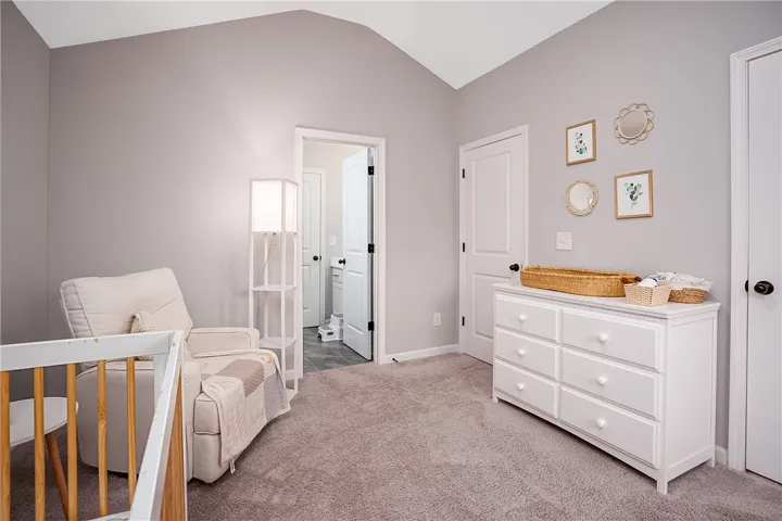 A comforting bedroom features vaulted ceilings creating a tranquil environment.