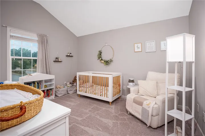 This naturally illuminated bedroom offers vaulted ceilings  ideal for peaceful slumber.