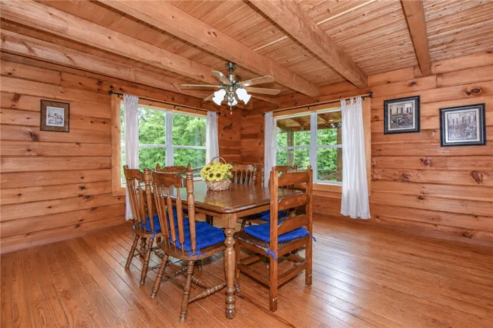 Natural wood floors and walls create a warm, inviting atmosphere in this dining area.