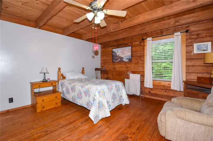 Natural wood paneling and exposed beams create a cozy, cabin-like ambiance.