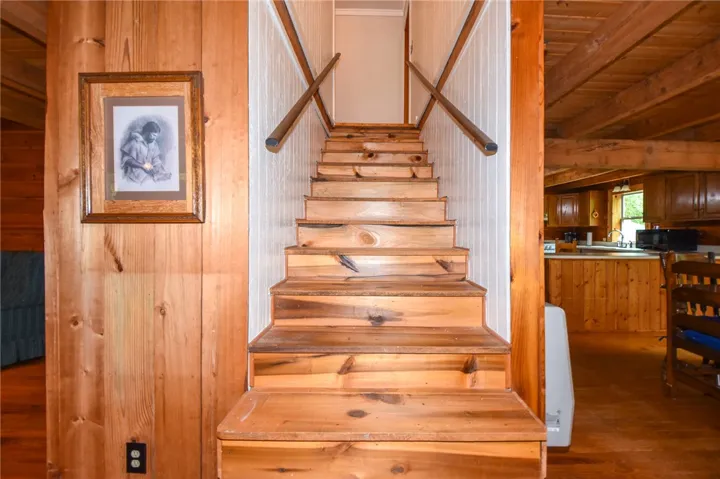 Natural wood tones grace this welcoming staircase, leading to a cozy second level.