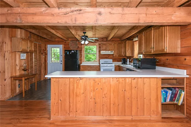 A well-equipped kitchen offers abundant wood cabinetry and a functional layout for culinary endeavors.