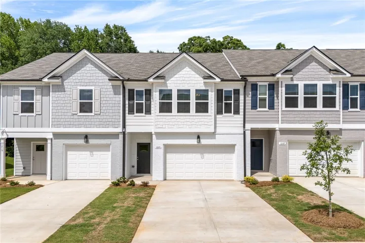 The townhomes feature well-maintained grounds and convenient individual garages.