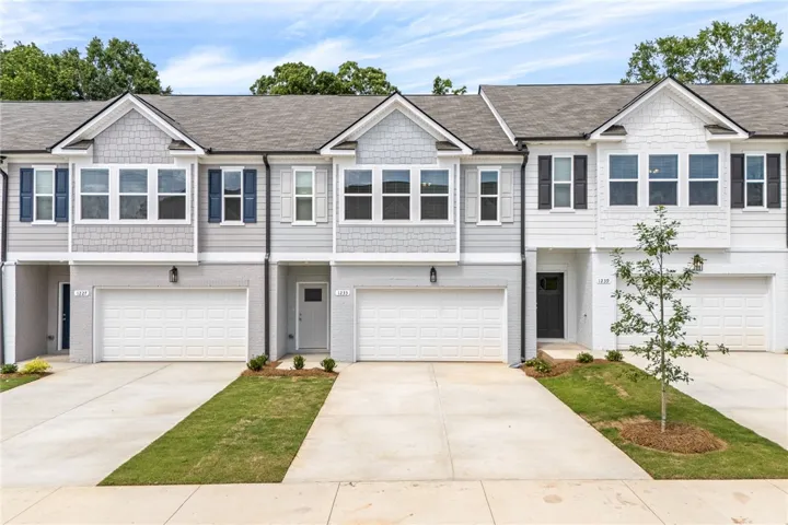 Contemporary townhomes feature durable fiber cement siding and attached garages, enhancing street appeal.