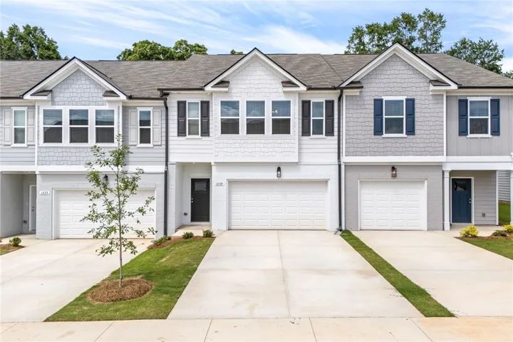 Clean lines and classic shutters define the charming facade of these inviting townhomes.