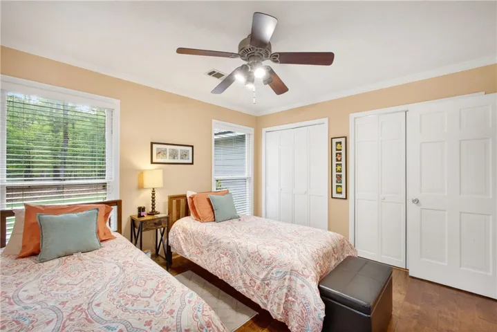 A comforting bedroom with warm tones, providing a serene retreat with natural light filtering through the windows.