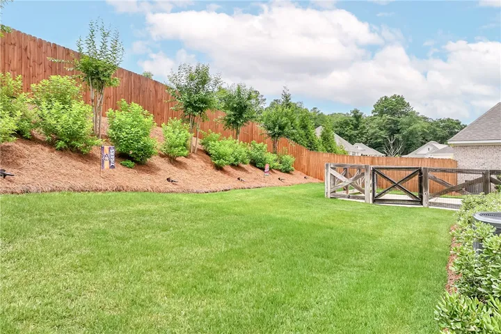 A manicured lawn and privacy fencing create a serene outdoor retreat.