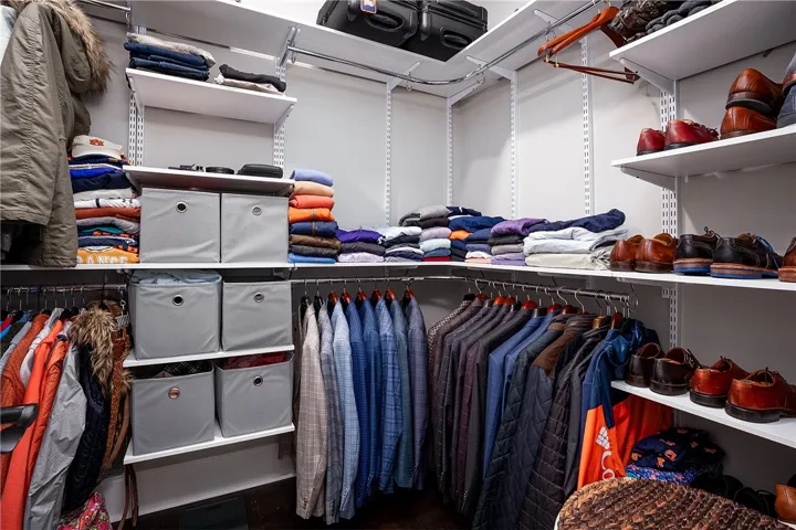 Large primary closet with custom shelving.