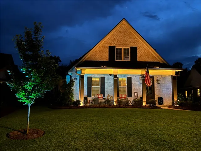 Well-illuminated facade and inviting front porch create striking curb appeal.
