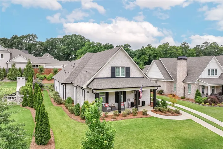 A well-maintained lawn and mature landscaping enhance this charming single-family home's curb appeal.