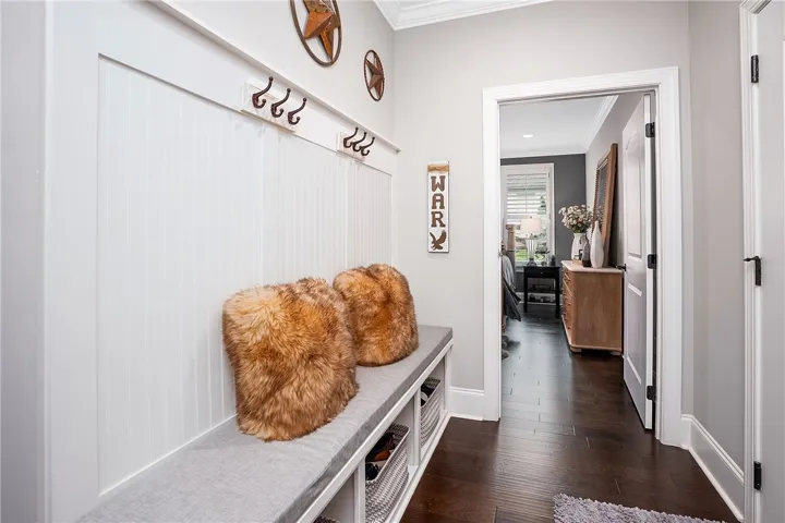Entry from garage features a drop zone with  built-in seating.