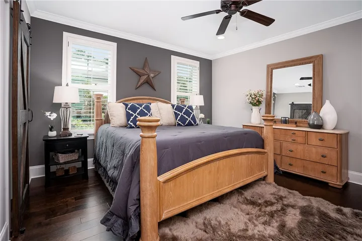 Hardwood floors and bright windows complete this comfortable primary bedroom.