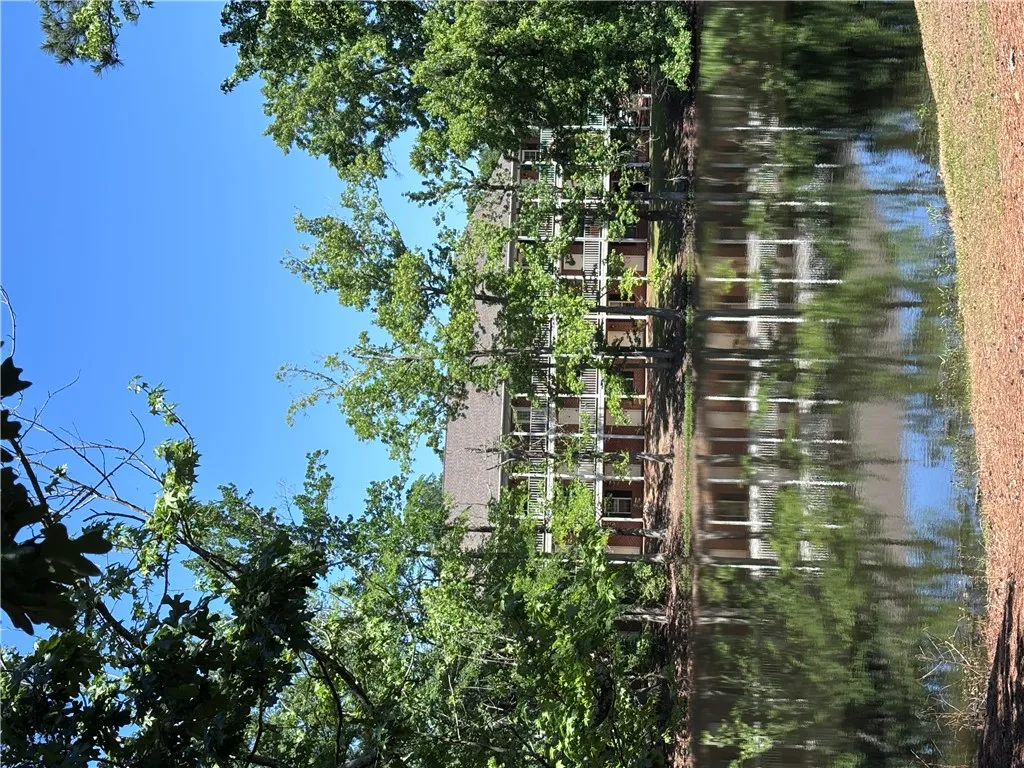 Reflecting water views complement this charming multi-story residence with serene natural surroundings.