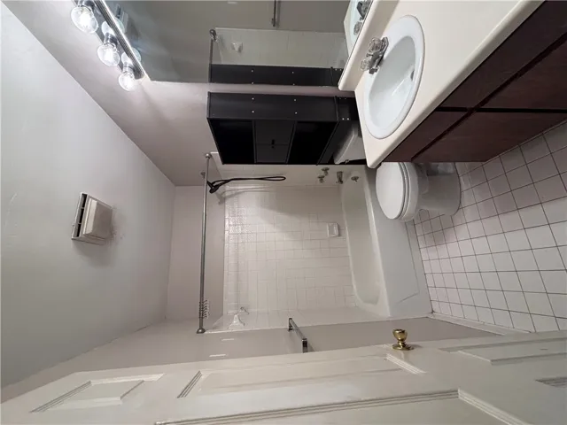 Tiled floor and shower surround create a clean, functional bathroom space.