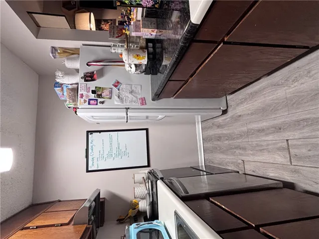 Functional kitchen with ample cabinet space, an electric range, and durable flooring.