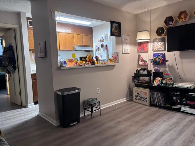 A streamlined open floorplan connects the living area to a pass-through kitchen, ideal for effortless entertaining.