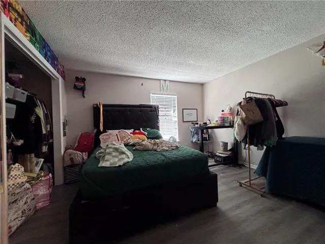 Comfortable bedroom offers ample space with practical flooring and a closet for organization.
