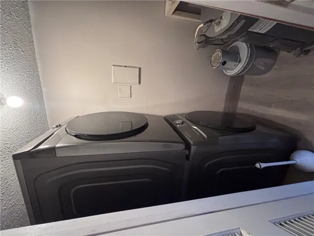 A dedicated utility space includes a full sized stacked washer and dryer unit for efficient living.