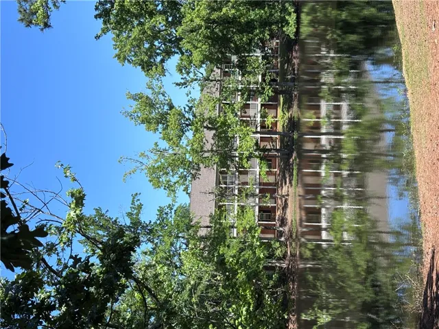 Reflecting water views complement this charming multi-story residence with serene natural surroundings.
