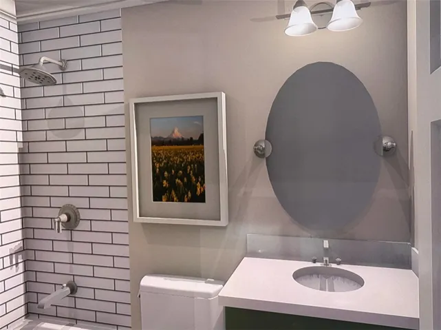 Clean lines define this bright bathroom, showcasing a subway tile shower and a contemporary vanity with a sleek mirror.