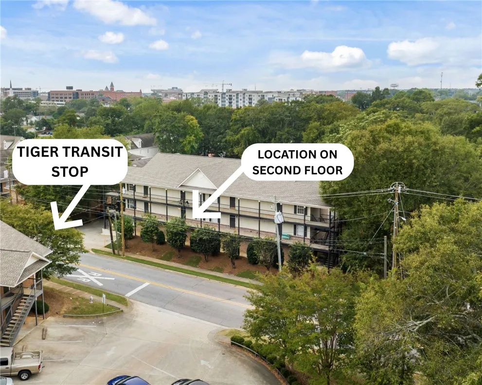 An aerial perspective reveals a charming multi-story residence nestled among mature trees, with convenient transit access.