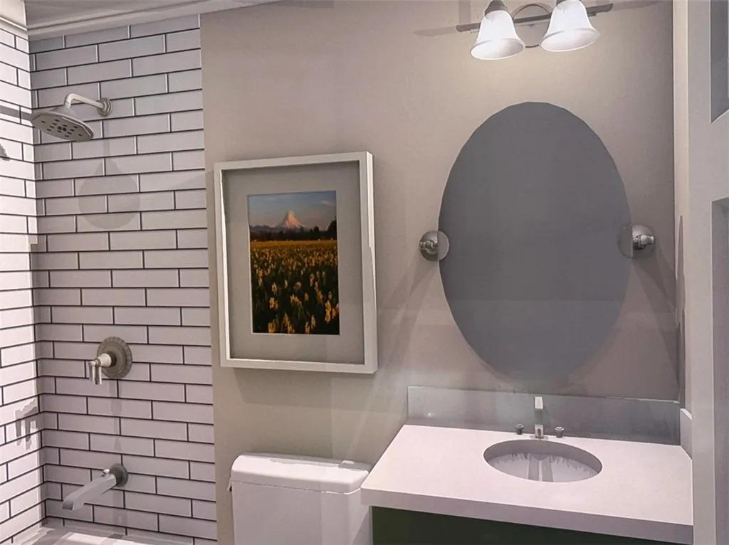 A pristine bathroom features subway tile, a sleek vanity, and an elegant oval mirror.