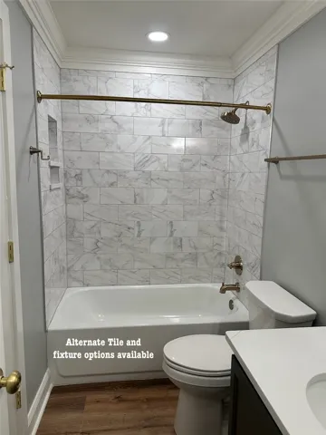 A well-appointed bathroom features a tub-shower combination with elegant tile surround.