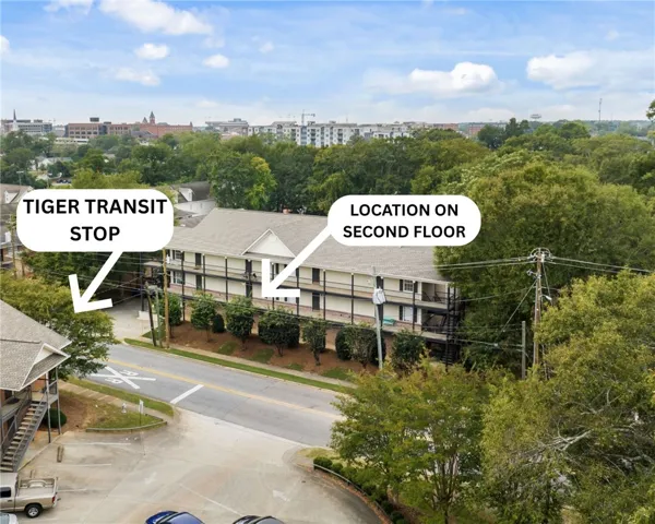 An aerial perspective reveals a charming multi-story residence nestled among mature trees, with convenient transit access.