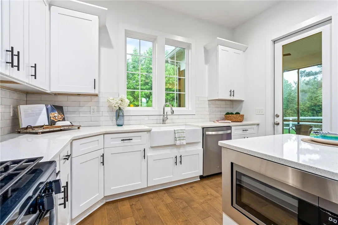 Farmhouse sink overlooks the wooded backyard.