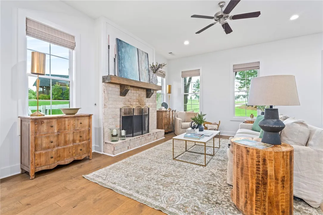 Open concept living room with wood burning fireplace.