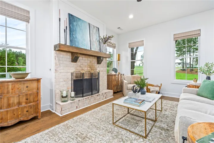 Open concept living room with wood burning fireplace.