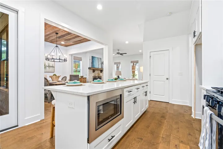 Kitchen overlooks living and dining area making entertaining a breeze.