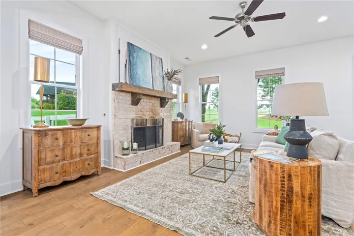Open concept living room with wood burning fireplace.