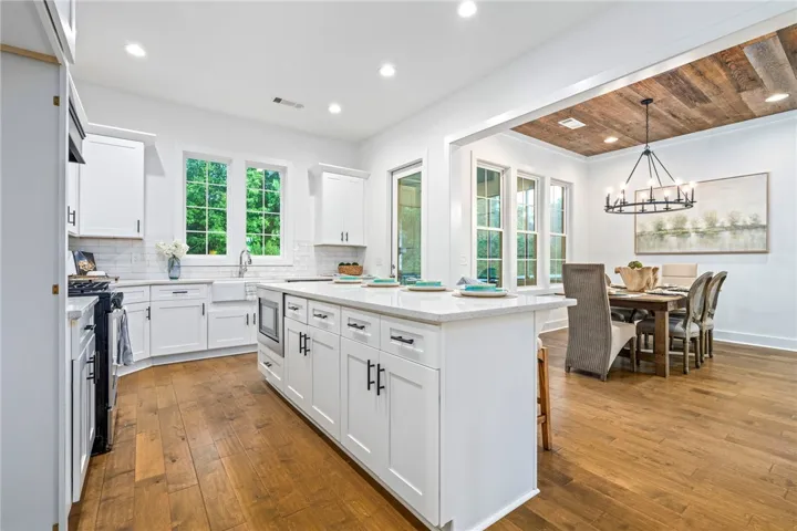 Kitchen overlooks living and dining area making entertaining a breeze.