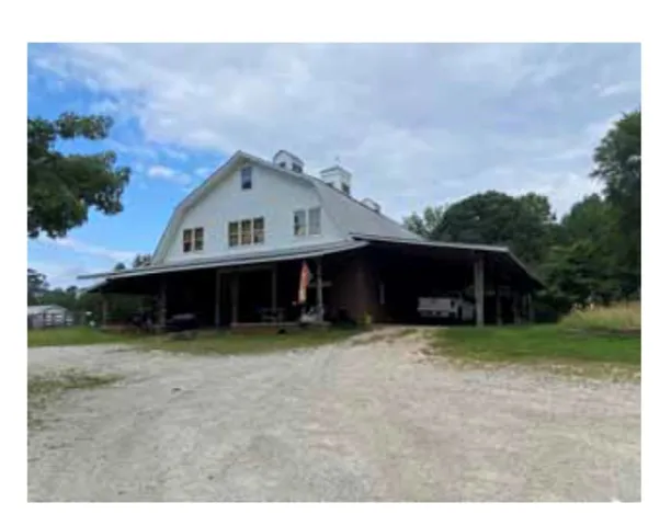 A spacious barn conversion with a broad covered patio offers versatile living and utility.