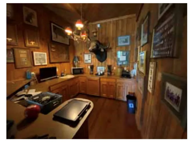 Rich wood paneling envelops this charming bar area, offering ample counter space for entertaining.
