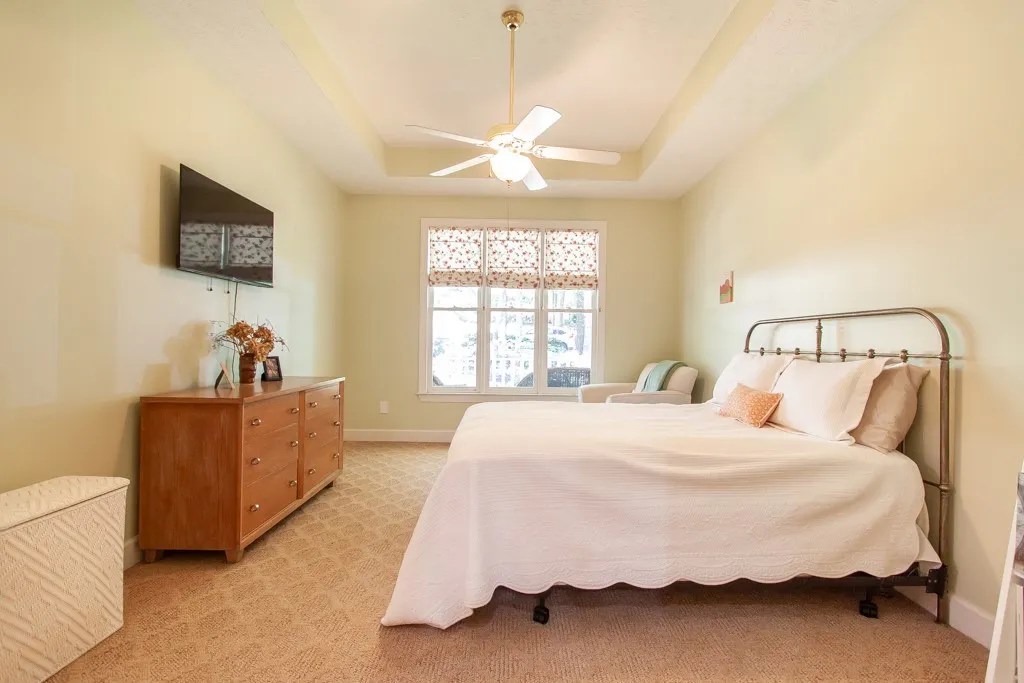 Recessed ceiling and ample natural light define this cozy bedroom retreat.