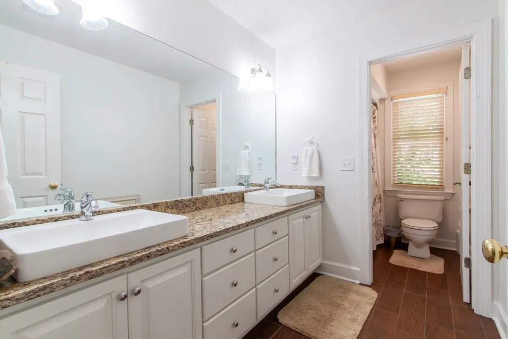 Bath 2- The bath on the second floor features Granite counters and dual vessel sinks. Separate toilet/tub area.