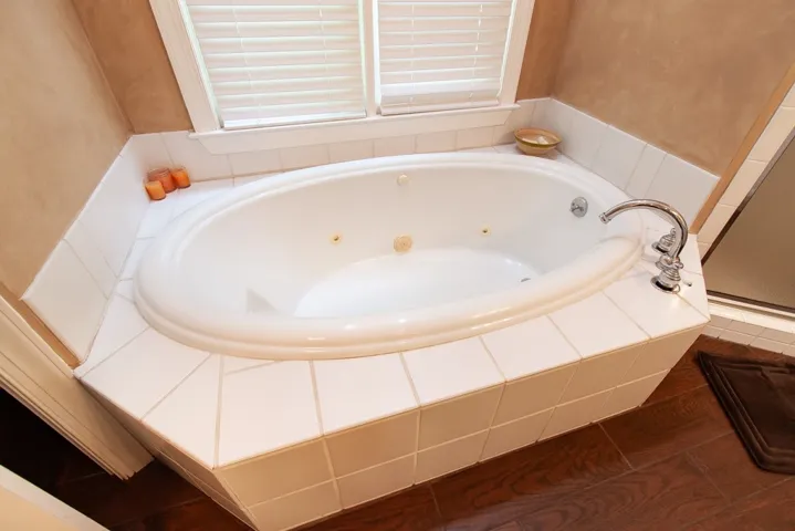 Indulge in a spa tub, complete with tile surround.