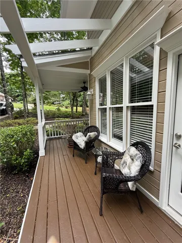 An inviting covered porch extends a warm welcome with ample space for outdoor relaxation.
