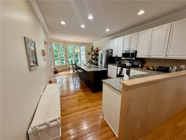 Prepare meals in this light-filled kitchen, featuring ample counter space and a central island with bar seating.