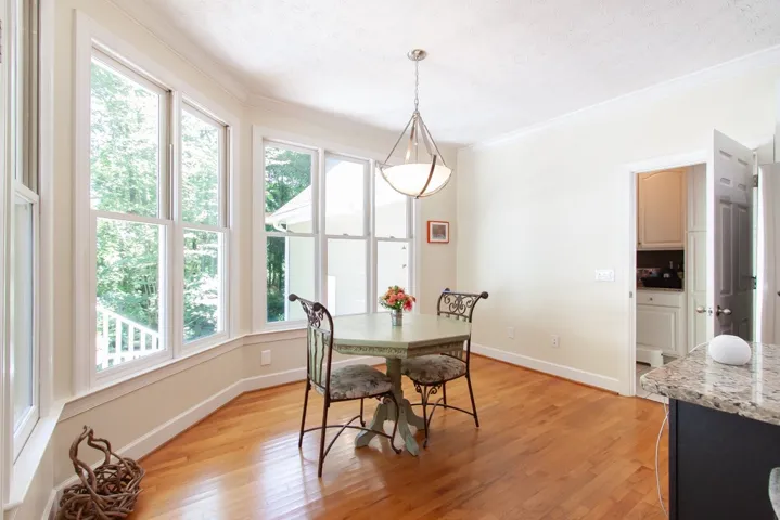 Sun-filled breakfast area with gleaming hardwood floors, perfect for morning gatherings.