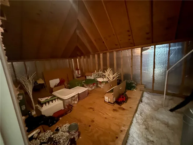 Ample walk-in attic storage space with convenient wood flooring.