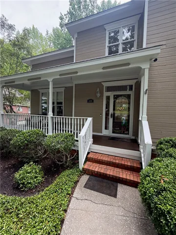 An inviting front porch with brick stairs welcomes guests to this charming residence.