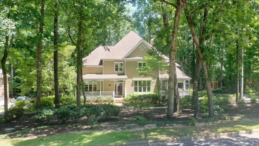 Nestled amidst mature trees, this residence offers a private, welcoming facade.