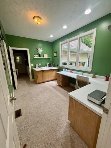 A dedicated home office provides built-in desks and ample natural illumination.