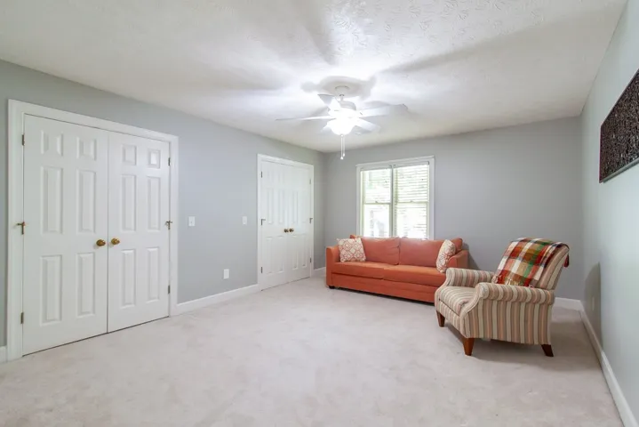 A quiet retreat with plush carpeting and ample natural light, ideal for peaceful moments.
